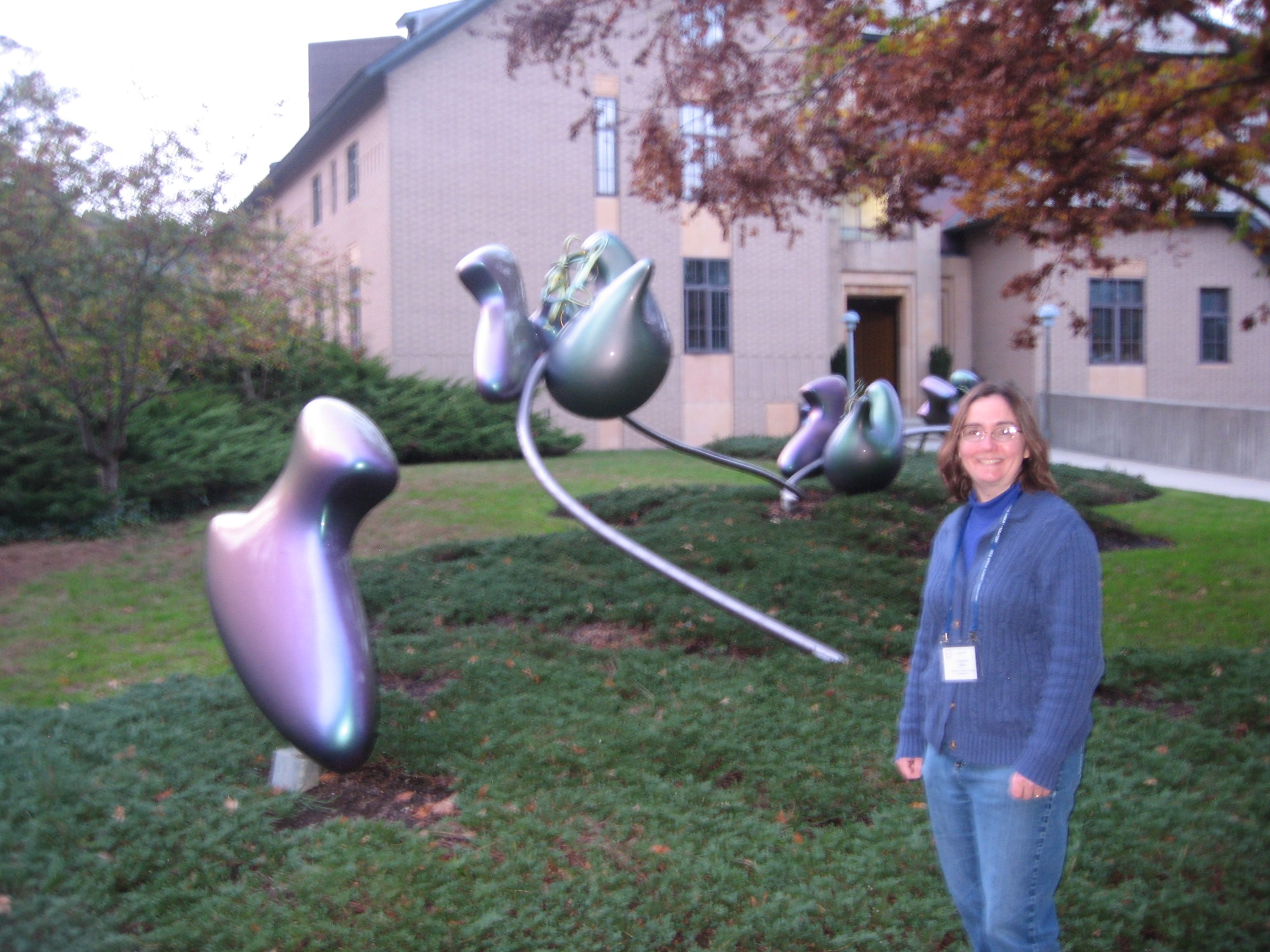 Constance Jeffery poses in front of a ribosome sculpture at a Cold Spring Harbor meeting.