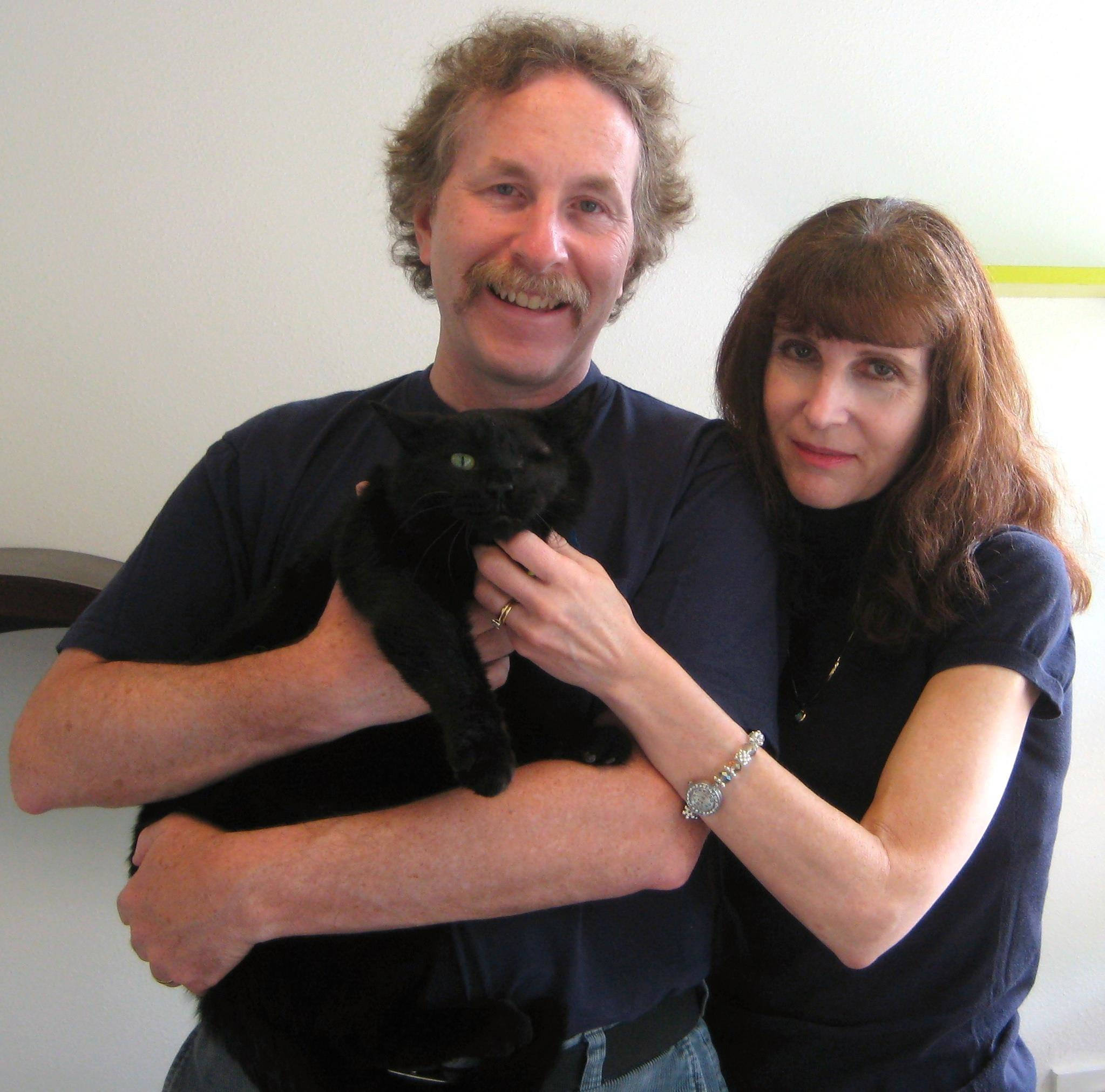 An adoption photo from PAWS Cat City in Seattle shows James Abney and wife Bethe Scalettar adopting their newest special-needs cat, Ranger.