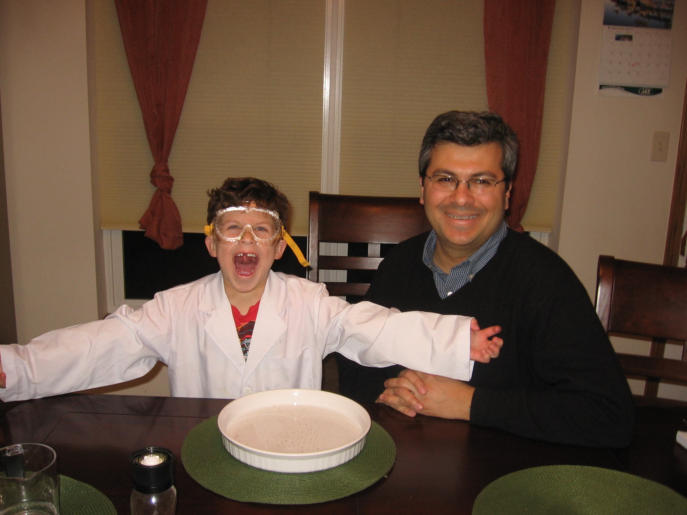 Taner Sen and his son Burak conducting science experiments in Sen’s kitchen.