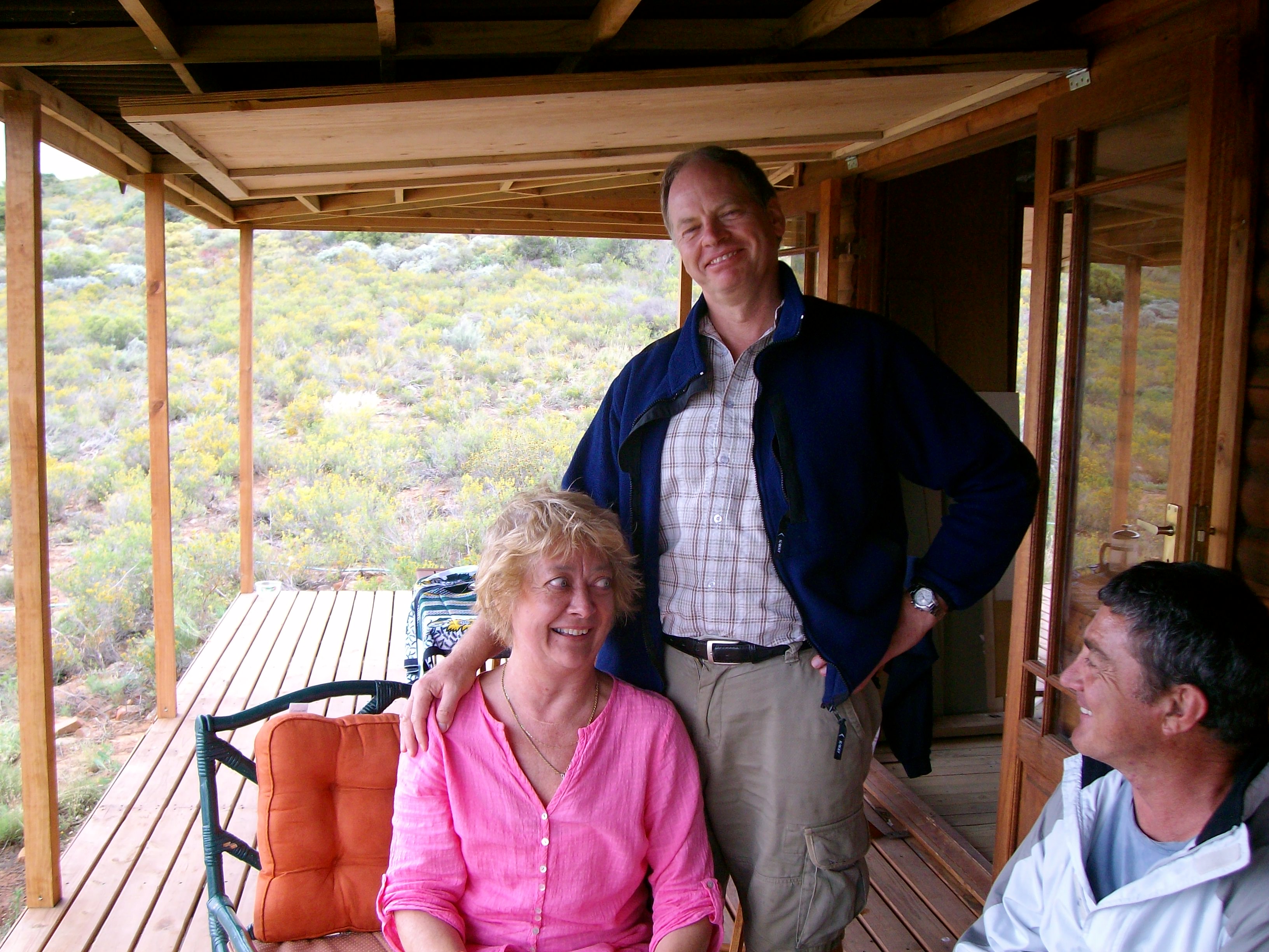Sewell with his wife at their log cabin.