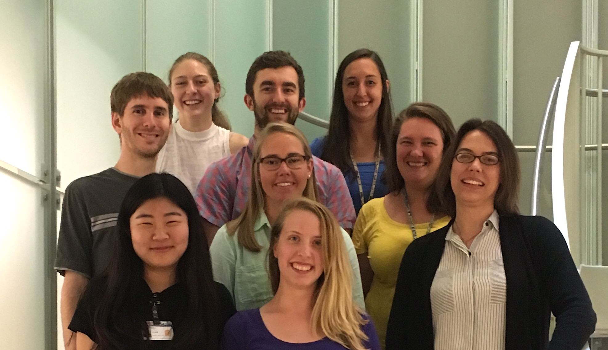 Columbus with her lab. From left to right, front row: Katie Ahn, Nicole Swope, Linda Columbus. Next row: Jason Kuhn, Tracy Caldwell, Jennifer Martin. Back row: Katherine Lake, Steven Keller, Marissa Kieber