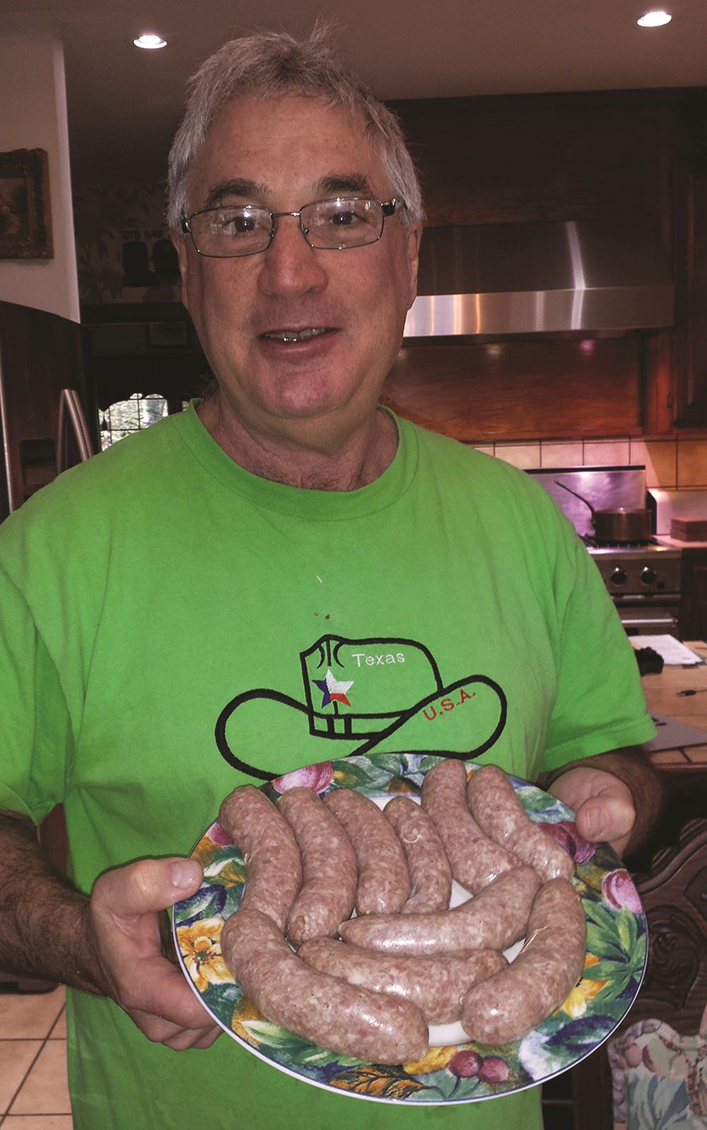Egelman in his kitchen displaying his freshly made sausages.